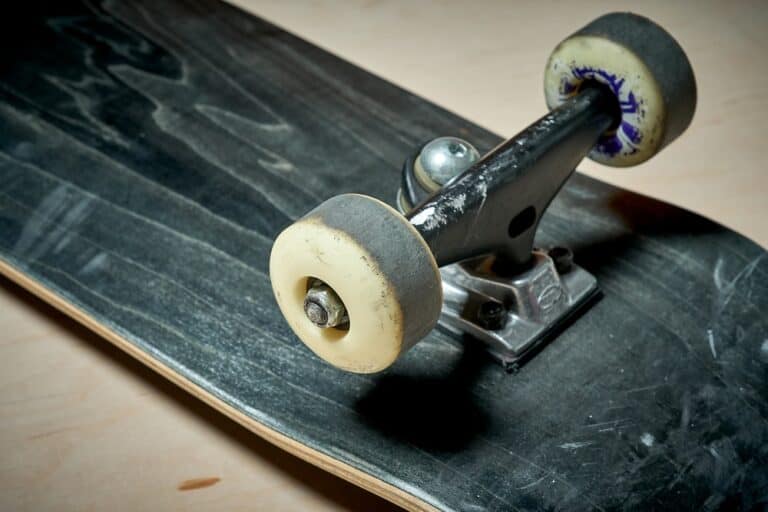 closeup of skateboard wheels covered in asphalt