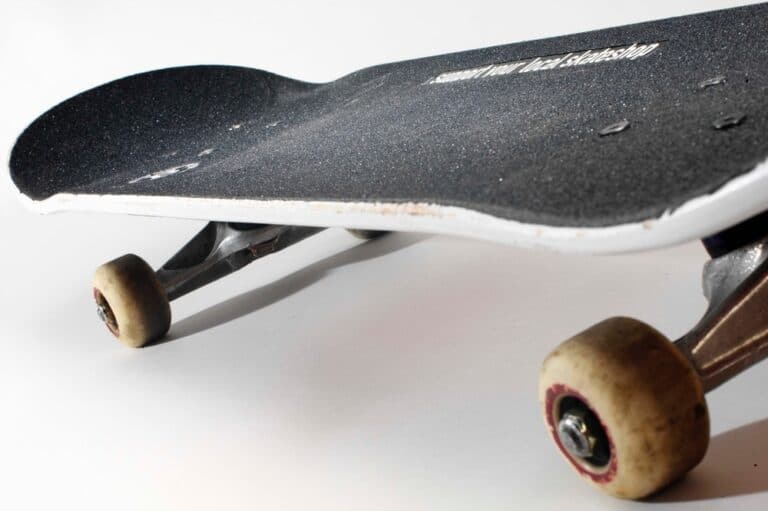 well used skateboard on white background
