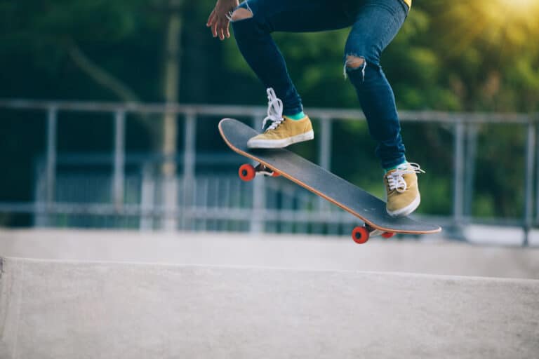 close up of man doing an ollie on a skateboard