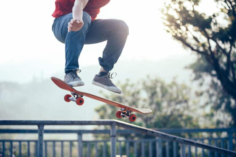 man on a skateboard performing tricks at a skate park