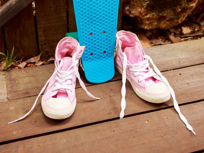 close up of girls pink converse skateboarding shoes